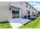 A nice back patio with sliding doors and a well manicured lawn at 550 Zinfandel Dr, Daytona Beach, FL 32117