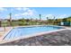 A refreshing community pool with a lake view and decorative fencing at 550 Zinfandel Dr, Daytona Beach, FL 32117