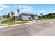 Community entrance featuring a security building, palm trees, and wrought iron fencing at 552 Zinfandel Dr, Daytona Beach, FL 32117