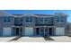 Newly constructed townhomes offer modern exteriors with individual garages and landscaped front yards at 552 Zinfandel Dr, Daytona Beach, FL 32117