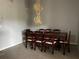 Formal dining area featuring a classic chandelier, carpet, and ample seating for gatherings at 567 Queensbridge Dr, Lake Mary, FL 32746