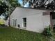 Exterior shot of a home showing gray stucco siding with brick detail, lawn and windows at 567 Queensbridge Dr, Lake Mary, FL 32746