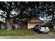 Inviting single-story home with a two-car garage and mature trees shading the front yard at 567 Queensbridge Dr, Lake Mary, FL 32746