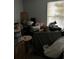 Dimly lit living room featuring an assortment of furniture, decorations, and personal belongings by a window at 567 Queensbridge Dr, Lake Mary, FL 32746