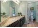 Bathroom with a granite-topped vanity, large mirror, and an adjacent toilet at 595 American Holly Pl, Oviedo, FL 32765