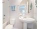 Bathroom featuring white fixtures, a pedestal sink, and a shower-tub combo at 595 American Holly Pl, Oviedo, FL 32765