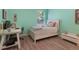 Bright bedroom featuring a well-lit window, a desk, and comfortable decor at 595 American Holly Pl, Oviedo, FL 32765