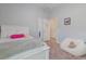 Bright bedroom with white trim, a plush beanbag chair and light pink accent rug at 595 American Holly Pl, Oviedo, FL 32765
