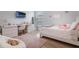 Stylized bedroom featuring light grey walls, wood floors, desk and plush pink accents at 595 American Holly Pl, Oviedo, FL 32765
