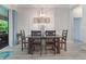 Bright dining room boasts a modern chandelier and direct access to the outdoor patio at 595 American Holly Pl, Oviedo, FL 32765