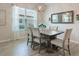 Elegant dining room with stylish chairs, a wooden table, and natural light streaming through the window at 595 American Holly Pl, Oviedo, FL 32765