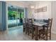 Inviting dining area with backyard views, bench seating, and access to the pool area at 595 American Holly Pl, Oviedo, FL 32765
