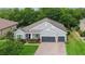 Aerial view of a lovely home with lush greenery, a well-maintained lawn, and a spacious driveway at 595 American Holly Pl, Oviedo, FL 32765