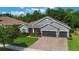 Charming single-Gathering home with a well-maintained lawn, mature landscaping, and a three-car garage at 595 American Holly Pl, Oviedo, FL 32765