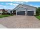 Charming home exterior with well-manicured lawn, mature landscaping, and a two-car garage at 595 American Holly Pl, Oviedo, FL 32765