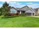 Beautiful single-Gathering home featuring lush green lawn and vibrant landscaping in a well-maintained yard at 595 American Holly Pl, Oviedo, FL 32765