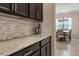 Kitchen counter with gray tile backsplash and dark cabinets at 595 American Holly Pl, Oviedo, FL 32765