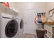 Bright laundry room featuring modern washer and dryer, shelving, and ample storage space at 595 American Holly Pl, Oviedo, FL 32765