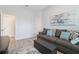 A living room with a comfortable sofa, stylish ottoman, and artwork on the wall at 595 American Holly Pl, Oviedo, FL 32765