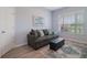 Comfortable living room featuring a gray sofa, decorative pillows, and a plush rug for a cozy ambiance at 595 American Holly Pl, Oviedo, FL 32765
