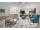 Open-concept living room features a plush sectional, stylish rug, and seamless flow into the kitchen and dining areas at 595 American Holly Pl, Oviedo, FL 32765