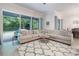 Cozy living room featuring a large sectional sofa, stylish rug, and ample natural light from sliding glass doors at 595 American Holly Pl, Oviedo, FL 32765