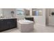 Luxurious main bathroom features a soaking tub, dual vanities, and a separate shower at 595 American Holly Pl, Oviedo, FL 32765