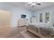Bright bedroom featuring French doors to backyard, dresser and television set at 595 American Holly Pl, Oviedo, FL 32765