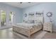 Serene main bedroom with French doors leading to outdoor patio, calming color palette, and ample natural light at 595 American Holly Pl, Oviedo, FL 32765