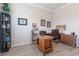 Home office featuring wood flooring, functional desk, and decorative touches for a productive workspace at 595 American Holly Pl, Oviedo, FL 32765