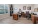 Spacious home office featuring wood flooring, functional desk, and natural light from a large window at 595 American Holly Pl, Oviedo, FL 32765