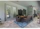 Covered patio featuring an outdoor dining set and a view of the swimming pool at 595 American Holly Pl, Oviedo, FL 32765