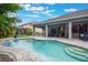Inviting backyard pool area featuring a lovely waterfall feature and a covered patio for outdoor relaxation at 595 American Holly Pl, Oviedo, FL 32765