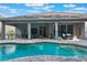 Beautiful backyard featuring a sparkling pool, covered patio, and ample space for outdoor relaxation and entertainment at 595 American Holly Pl, Oviedo, FL 32765