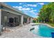 Stunning backyard with a sparkling pool and covered patio, perfect for outdoor living and entertaining at 595 American Holly Pl, Oviedo, FL 32765