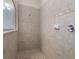 Bright bathroom featuring a tile shower with a decorative accent tile at 595 American Holly Pl, Oviedo, FL 32765