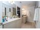 Spacious bathroom with double sinks, ample counter space, and walk-in closet offers both style and functionality at 6543 Orange Cream Aly, Winter Garden, FL 34787