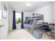 Charming bedroom with bunk beds, playful decor, and bright window offers a cheerful space for  at 6543 Orange Cream Aly, Winter Garden, FL 34787