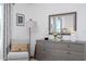 Tastefully decorated bedroom with stylish decor, gray dresser, and soft light creates inviting atmosphere at 6543 Orange Cream Aly, Winter Garden, FL 34787
