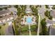 Aerial view of a community pool, showcasing its layout with palm trees, lounge chairs, and surrounding greenery at 6543 Orange Cream Aly, Winter Garden, FL 34787