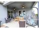 The covered patio features ceiling fans, a dining table, and a hanging lounge chair at 6543 Orange Cream Aly, Winter Garden, FL 34787