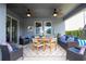 The covered patio is set up for dining and relaxing with ceiling fans and comfortable seating at 6543 Orange Cream Aly, Winter Garden, FL 34787