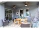 The covered patio offers an inviting space with ceiling fans, dining, and lounge seating at 6543 Orange Cream Aly, Winter Garden, FL 34787