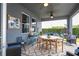 The covered patio features ceiling fans, a dining table, and lounge furniture at 6543 Orange Cream Aly, Winter Garden, FL 34787