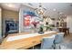 Elegant dining room featuring a wooden table, gray chairs, chandelier, and colorful abstract artwork at 6543 Orange Cream Aly, Winter Garden, FL 34787