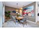 Stylish dining area featuring a wooden table, gray chairs, modern decor, and natural light from the sliding glass door at 6543 Orange Cream Aly, Winter Garden, FL 34787