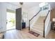 Bright entryway with wood-look tile flooring, staircase, and open access to other rooms at 6543 Orange Cream Aly, Winter Garden, FL 34787