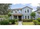 Charming two-story home with manicured landscaping, inviting curb appeal, and gray siding at 6543 Orange Cream Aly, Winter Garden, FL 34787