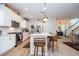 Modern kitchen with white cabinets, stainless steel appliances, and a breakfast bar with seating at 6543 Orange Cream Aly, Winter Garden, FL 34787