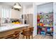 Pantry featuring ample storage in a modern kitchen with white cabinets and stainless-steel appliances at 6543 Orange Cream Aly, Winter Garden, FL 34787